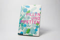 Das Buch "Pillen und Pipetten" steht vor einem weißen Hintergrund